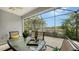 Enclosed patio with table and chairs overlooking a pond at 21042 Anclote Ct, Venice, FL 34293