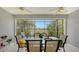 Enclosed patio with table and chairs overlooking a pond at 21042 Anclote Ct, Venice, FL 34293