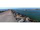 Fishing pier extending into the ocean with a boat passing by at 21042 Anclote Ct, Venice, FL 34293