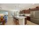 Open concept kitchen with hardwood cabinets and island, stainless steel appliances at 21042 Anclote Ct, Venice, FL 34293