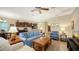 Living room with light blue sofa, coffee table, and view of kitchen at 21042 Anclote Ct, Venice, FL 34293