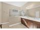 Double vanity bathroom with a large walk-in shower at 21208 Sandal Foot Dr, Venice, FL 34293