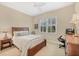 Charming bedroom with a queen bed, window seating and wood accents at 21208 Sandal Foot Dr, Venice, FL 34293