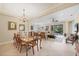 Elegant dining room features a large wood table and chandelier at 21208 Sandal Foot Dr, Venice, FL 34293