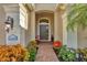 Brick walkway to front door, flanked by planters and lighting at 21208 Sandal Foot Dr, Venice, FL 34293