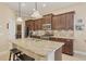 Open kitchen with granite island, stainless appliances, and view to living room at 21208 Sandal Foot Dr, Venice, FL 34293