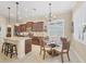 Island kitchen with granite countertops, dark wood cabinets, and breakfast nook at 21208 Sandal Foot Dr, Venice, FL 34293