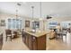 Spacious kitchen with breakfast bar, granite countertops, and dark cabinets at 21208 Sandal Foot Dr, Venice, FL 34293