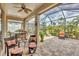 Spacious screened lanai with paver tile floor and outdoor seating at 21208 Sandal Foot Dr, Venice, FL 34293