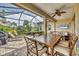 Covered lanai with outdoor dining and seating area at 21208 Sandal Foot Dr, Venice, FL 34293