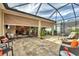 Large lanai with automated shades, comfortable seating, and views at 21208 Sandal Foot Dr, Venice, FL 34293