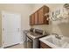 Laundry room with washer, dryer, cabinets, and sink at 21208 Sandal Foot Dr, Venice, FL 34293