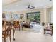 Open living room and kitchen with tile floors and access to lanai at 21208 Sandal Foot Dr, Venice, FL 34293