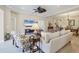 Open living space with neutral decor, sofa, chairs, and view to dining area at 21208 Sandal Foot Dr, Venice, FL 34293