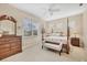 Spacious main bedroom with a post bed, plenty of light, and a dresser at 21208 Sandal Foot Dr, Venice, FL 34293
