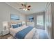 Bright bedroom featuring a bed with a light grey headboard, white linens, and nightstands with lamps at 215 Portia N St, Nokomis, FL 34275