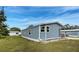 Well-maintained single-story home featuring blue siding, complemented by lush green lawn at 215 Portia N St, Nokomis, FL 34275
