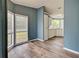 Bright kitchen area features white cabinetry, tile backsplash, laminate countertops, wood-look flooring, and stainless-steel sink at 215 Portia N St, Nokomis, FL 34275