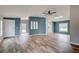 Open-concept living room with stylish wood-look floors, neutral paint, and updated fixtures at 215 Portia N St, Nokomis, FL 34275