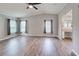 Spacious main bedroom features wood-look floors, large windows, ceiling fan, and ensuite bath at 215 Portia N St, Nokomis, FL 34275