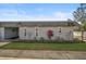 Gray exterior condo with well-manicured landscaping and a paved walkway at 4160 Fruitville Rd # 14, Sarasota, FL 34232