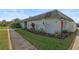 Gray building exterior with landscaping and walkway at 4160 Fruitville Rd # 14, Sarasota, FL 34232