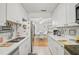 Kitchen with white cabinets, stainless steel appliances, and view into dining area at 4160 Fruitville Rd # 14, Sarasota, FL 34232