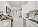 White cabinets, stainless steel appliances, and quartz countertops in this galley kitchen at 4160 Fruitville Rd # 14, Sarasota, FL 34232