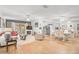 Open living and dining area with light wood floors and a fireplace at 4160 Fruitville Rd # 14, Sarasota, FL 34232