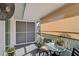 Relaxing screened porch with seating area and tropical plants at 4160 Fruitville Rd # 14, Sarasota, FL 34232