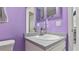 Clean bathroom with a single sink and purple walls at 4666 La Rosa Ave, North Port, FL 34286