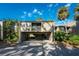 Exterior view of condo with carport and lush landscaping at 752 Pine Run Dr, Osprey, FL 34229