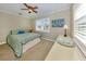 Bright bedroom with a king-size bed, striped comforter, and window shutters at 828 Nokomis S Ave, Venice, FL 34285