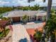 Charming home with a paver driveway, lush landscaping, and a welcoming front entrance at 922 Casey Cove Dr, Nokomis, FL 34275