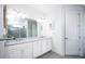 Double vanity bathroom with white cabinets and a large mirror at 9401 President Cir, Port Charlotte, FL 33981