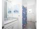 Bathroom with flamingo shower curtain and double vanity at 9401 President Cir, Port Charlotte, FL 33981