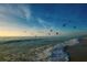 Stunning beach view at sunset with birds in flight and sailboat at 9401 President Cir, Port Charlotte, FL 33981