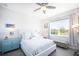 Bedroom with a queen-size bed, light blue dresser, and large window at 9401 President Cir, Port Charlotte, FL 33981