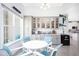 Bright breakfast nook with a white table and blue chairs, built in cabinets and kitchen views at 9401 President Cir, Port Charlotte, FL 33981