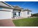 Light gray house with a two-car garage and landscaped lawn at 9401 President Cir, Port Charlotte, FL 33981