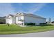Light gray house with a two-car garage and neatly landscaped yard at 9401 President Cir, Port Charlotte, FL 33981