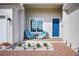 Relaxing front porch with blue chairs and brick flooring at 9401 President Cir, Port Charlotte, FL 33981
