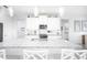 Modern kitchen with white cabinets, granite countertops and a large island at 9401 President Cir, Port Charlotte, FL 33981