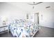 Main bedroom with king-size bed, white dresser, and ceiling fan at 9401 President Cir, Port Charlotte, FL 33981
