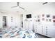 Main bedroom with king-size bed, white dresser, and wall-mounted TV at 9401 President Cir, Port Charlotte, FL 33981