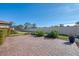 Spacious backyard with brick pavers and lush landscaping at 9847 Haze Dr, Venice, FL 34292