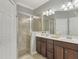 Elegant bathroom with double vanity and shower at 9847 Haze Dr, Venice, FL 34292