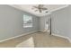 Bright bedroom with ceiling fan and tile floors at 9847 Haze Dr, Venice, FL 34292