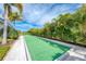 Landscaped bocce ball court with palm trees at 9847 Haze Dr, Venice, FL 34292