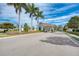 Gated entrance to a community with palm trees and landscaping at 9847 Haze Dr, Venice, FL 34292
